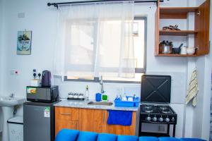 a small kitchen with a sink and a stove at Adristar Homes Ruiru Membley in Ruiru +9 photos