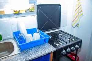 a kitchen with a stove with a blue tray on it at Adristar Homes Ruiru Membley in Ruiru