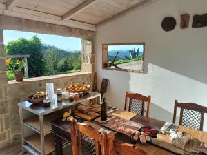 a dining room with a table and a large window at B&b da Elena e Davide in San Donato in Taviglione