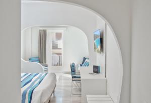 a bedroom with a bed and a table and a mirror at Luma Relais de Charme in Santa Teresa Gallura +199 photos