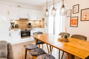 a kitchen and dining room with a wooden table and chairs at Huxfeld-Hof - Wümme in Grasberg +13 photos