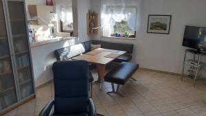 a dining room with a table and chairs and a television at Ferienwohnung Winkler in Bad Schandau