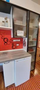 a refrigerator with a counter with scissors on it at B&B da Gi&Jo in Forgaria nel Friuli