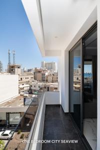 a balcony with a view of a city at Lazuli Seaview Apartments 2Bdr in Larnaka +128 photos