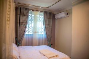 Postel nebo postele na pokoji v ubytování Spring Apartments & Suites