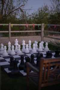 a chess board on the grass with a giant chessboardaza at The Shippon Barn - A delightful haven for families in Wirral