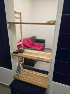 a room with a bunk bed with a red bed at 100m da praia de Copacabana in Rio de Janeiro
