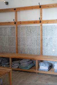 a shelf in a bathroom with folded towels at The Shippon Barn - A delightful haven for families in Wirral
