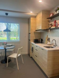 a kitchen with a sink and a table with a chair at Window to Paris Studio on Lake Conroe in Montgomery +9 photos