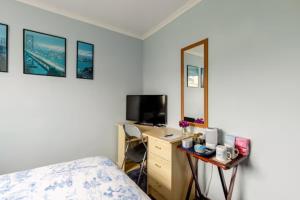a bedroom with a bed and a desk with a mirror at Bed & Breakfast Only - not 24 hour lodging - Truro, Cornwall - free parking in Truro