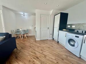a living room with a washing machine and a table at Swan House in Pallion