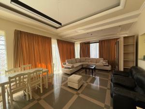 a living room with a couch and a table at Green Garden Villa in Durrës