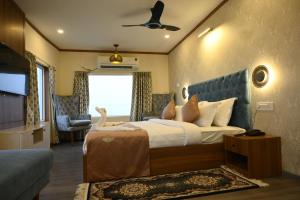 a bedroom with a bed and a chair and a window at Vikash Eco Resort in Bālugān