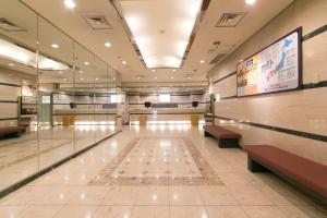 a lobby of a building with benches and a sign at Okayama Washington Hotel Plaza in Okayama