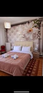 a bedroom with a large bed with a flower wallpaper at LUXURY APARTMENT Port of Piraeus in Piraeus