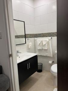 a white bathroom with a sink and a toilet at Cozy 2 bedroom retreat in Salem