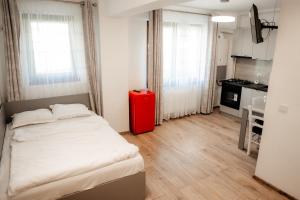 a room with a bed and a red refrigerator at Nips apartament in Condreni