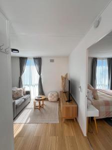 a bedroom with a bed and a living room at Bayside Bungalow in Frankston