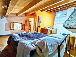 A bed or beds in a room at Case Rurali Pentedattilo