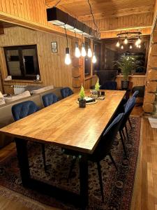 a dining room with a wooden table and chairs at Gorczańska Chata Lubomierz in Lubomierz