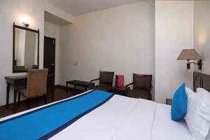 Postel nebo postele na pokoji v ubytování Collection O Hamilton Hotel