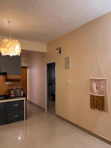 a living room with a kitchen and a room with a counter at Surreal Mountain View Studio in Canacona