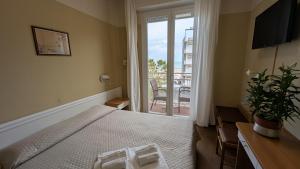 Postel nebo postele na pokoji v ubytování Hotel Boston