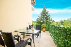 a patio with a table and chairs and a christmas tree at Semiramis Apartment in Potamós
