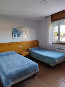 Postel nebo postele na pokoji v ubytování HOSTAL DON JAVIER