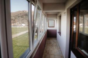 a hallway of a train with a view of a field at Don apartaments in Tîrgu Neamţ