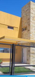 a view of a house from the outside through a glass door at Hermoso duplex a 500m del Paseo de la Costa in Neuquén