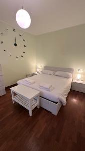 a bedroom with a white bed and a clock on the wall at Residenza la Sapienza in Viterbo