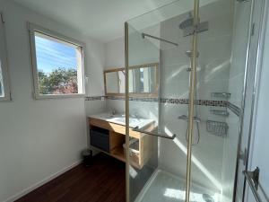 a bathroom with a glass shower and a sink at La Pause Binicaise - Maison proche plage in Binic-Etables-sur-Mer +13 photos