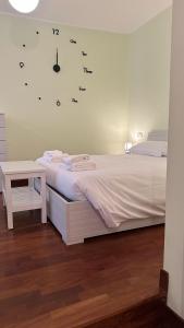 a bedroom with a bed and a clock on the wall at Residenza la Sapienza in Viterbo