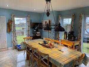 a dining room with a table and some chairs at Atlantic Bliss in Portstewart