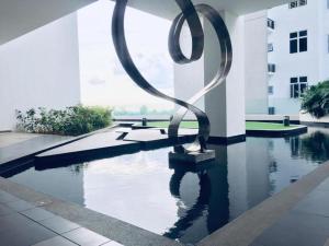 a sculpture in the middle of a pool in a building at ForeverHomeStayNilai in Nilai