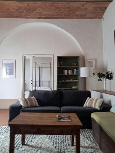 a living room with a couch and a coffee table at Agriturismo Il Pozzo in Greve in Chianti +14 photos