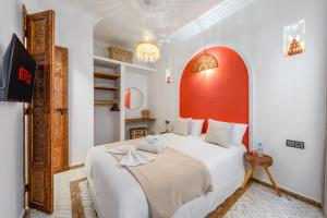 a bedroom with a large bed with a red headboard at Riad privatif 2 Chambres, Jacuzzi Proche des Palais in Marrakech