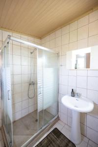 a bathroom with a glass shower and a sink at Nicola's House in Tsivarás +16 photos