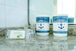 three coffee cups sitting on top of a counter at Maison Studios & Appartements Les 4 Vents in Luc-sur-Mer