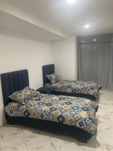 En eller flere senge i et værelse på Appartement haut standing