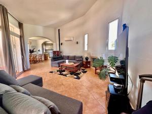 a living room with a couch and a table at Villa ADELE Binibeca sea view in Binibeca
