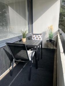 a table and a chair on a balcony at Compact apartment in Rauma in Rauma +6 photos