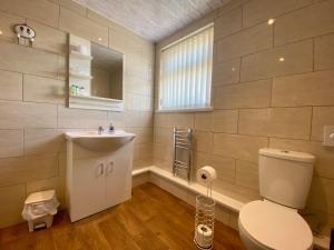 a bathroom with a toilet and a sink at The Libra - Adults Only B&B with guaranteed carpark in Blackpool +37 photos