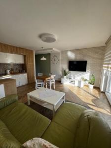a living room with a couch and a table at Apartament Eliza in Ustroń