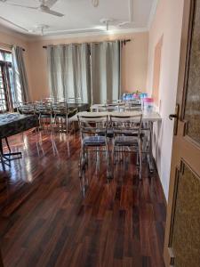 a dining room with a table and chairs at John's palace in Srinagar