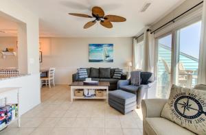 a living room with a couch and a ceiling fan at Royal Sands I B3: The Sandcastle by Carolina Beach Realty in Carolina Beach