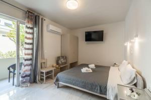 Posteľ alebo postele v izbe v ubytovaní Rhoe Seaside Apartments