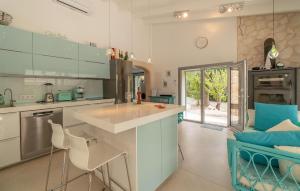 a kitchen with a counter and some chairs in it at Ca'n Fanals in Alcudia