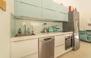 a kitchen with white cabinets and stainless steel appliances at Ca'n Fanals in Alcudia